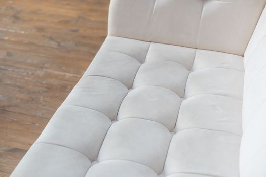 White quilted leather tiled texture sofa.