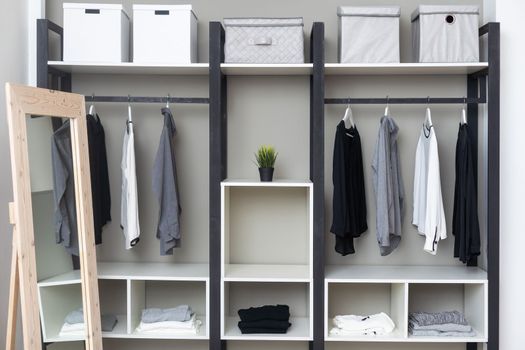 Youth cloths hanging in open wardrobe in the bedroom.