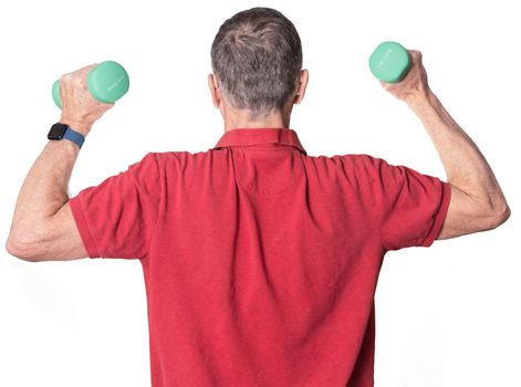 Senior man in red shirt exercising with arm or hand weights and isolated against white background