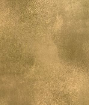 Close-up of an old cracked leather texture of golden green color.Texture or background