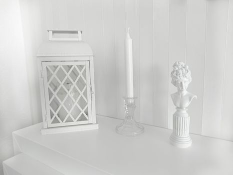 Texture or background.Composition on the fireplace with a lantern a candlestick and a statuette of a woman of bygone eras