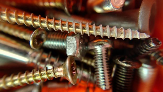 Bolts screws nuts of different sizes close-up.Macrophotography.Texture or background.Selective focus.