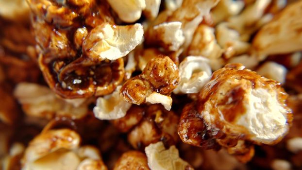 Selective focus of a handful of popcorn with caramel close-up.Macro photography.Texture or background.Selective focus.