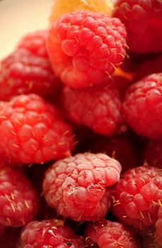 A handful of ripe garden raspberries in close-up.Macro photography.Texture or background.Selective focus.