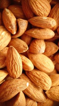 A handful of almonds in selective focus close-up.Macrophotography.Texture or background. Selective focus.