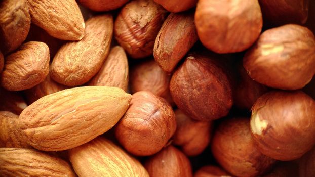 A mixture of almonds and hazelnuts in close-up.Macrophotography.Texture or background. Selective focus.