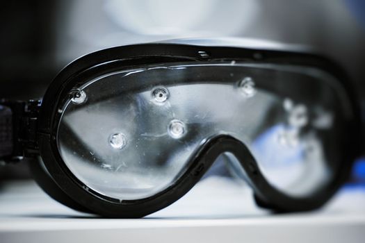 Safety goggles. Ballistic protective eyewear with plastic glasses. Protective ballistic goggles after testing. Protective sunglasses saved your eyes