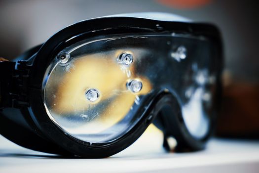 Safety goggles. Ballistic protective eyewear with plastic glasses. Protective ballistic goggles after testing. Protective sunglasses saved your eyes