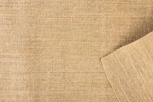 Texture of linen fabric in natural yellow color. The surface of the linen fabric as a background or banner, close-up