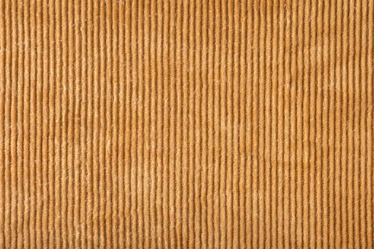 Texture of ribbed velvet. Texture of velvet fabric in light brown color with vertical stripes