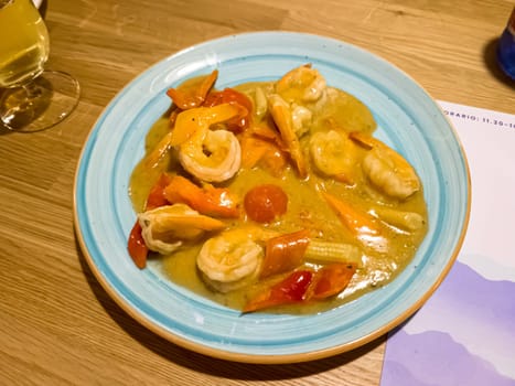 Indian spicy food shrimp curry prepared with coconut served as side dish.