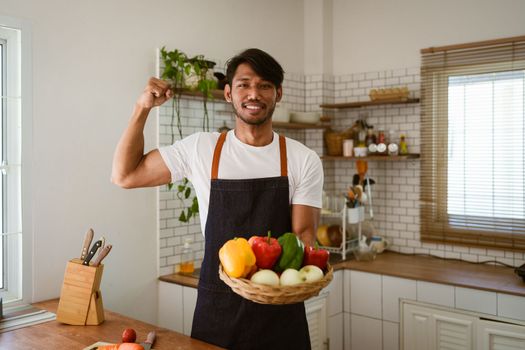 Portrait of asian man making salad at home. cooking food and Lifestyle moment.