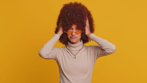 Young school girl feeling hopelessness and loneliness, nervous breakdown, loses becoming surprised by lottery results, bad fortune, loss, unlucky news, exam fail. Teen child kid on yellow background