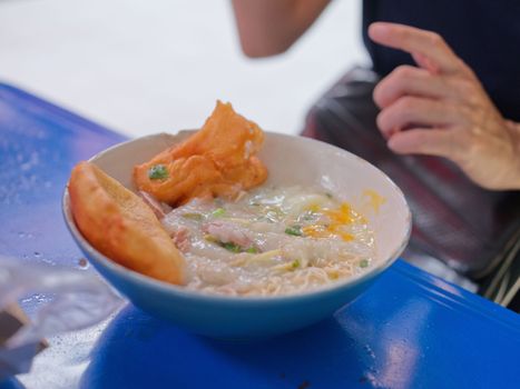 Chinese porridge with egg in a bowel with chinese donughnut . Concept breakfast set for marketing