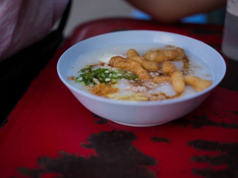 Chinese porridge with egg in a bowel with chinese donughnut . Concept breakfast set for marketing