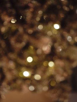 Christmas and Happy new year on blurred bokeh christmas tree . . Golden tone . SPACE FOR TEXT 