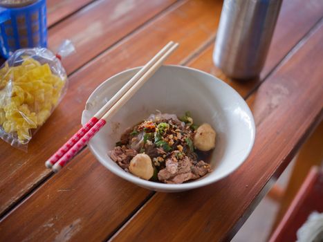 Thai Noodle beef is very delicious on wood table