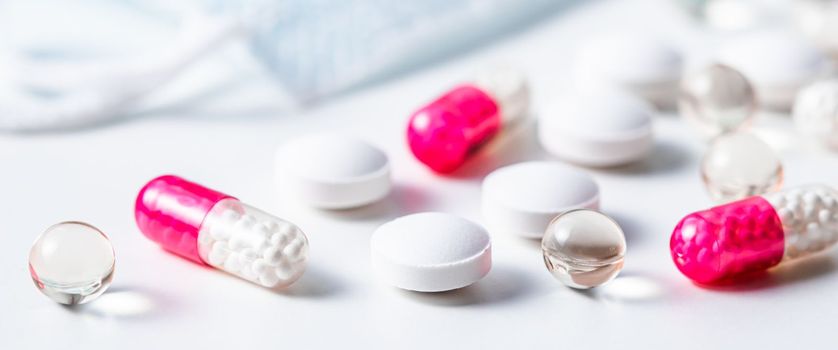 Red capsules, pills and medical masks on a white background. Health care, medical, pharmacy and illness concept