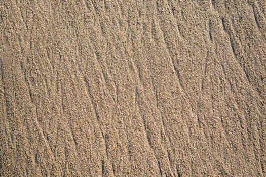 Natural sand texture background. sand on the beach as background. Wavy sand background for summer designs.