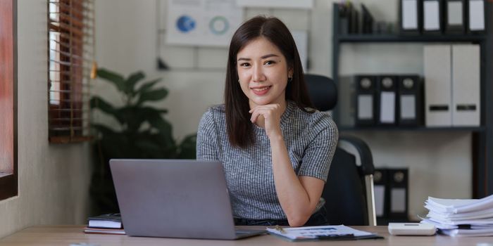Beautiful asian businesswoman working in office. business finance concept.
