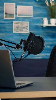 Empty podcast room with professional microphone in vlogger home studio in living. Influencer recording social media content with production microphone, digital web internet streaming station