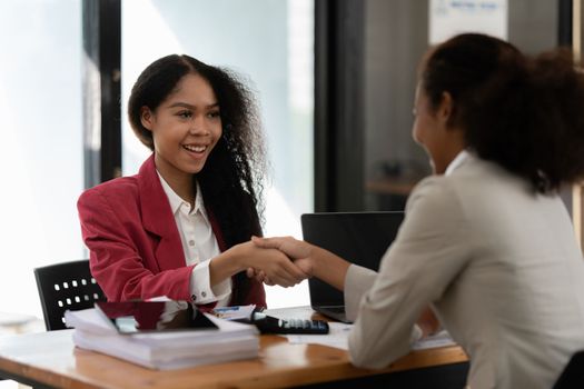 Image black business women handshake. Successful black business women handshaking after good deal. Group support concept.