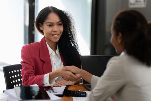 Image black business women handshake. Successful black business women handshaking after good deal. Group support concept.