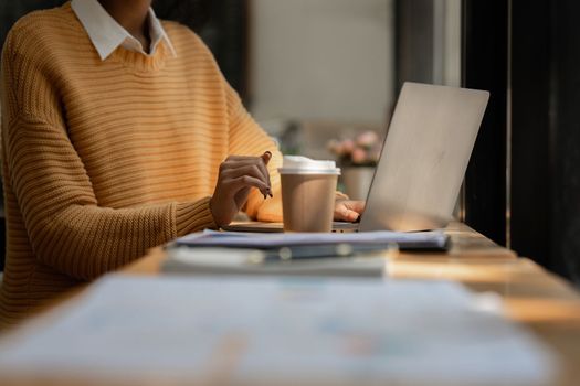 Portrait of asian beautiful young woman using laptop at home at morning.