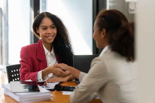 Image black business women handshake. Successful black business women handshaking after good deal. Group support concept.