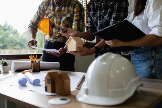 Architect man working with blueprints for architectural plan, engineer sketching a construction project concept.