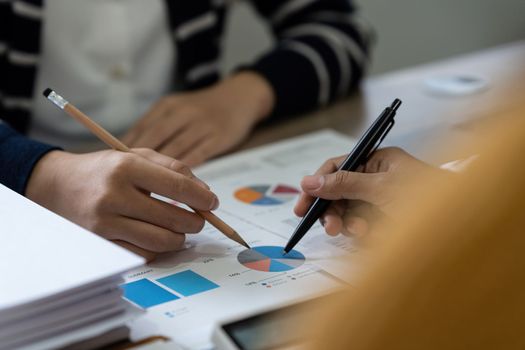 Group of business asian people analysis financial graph on desk at meeting room.