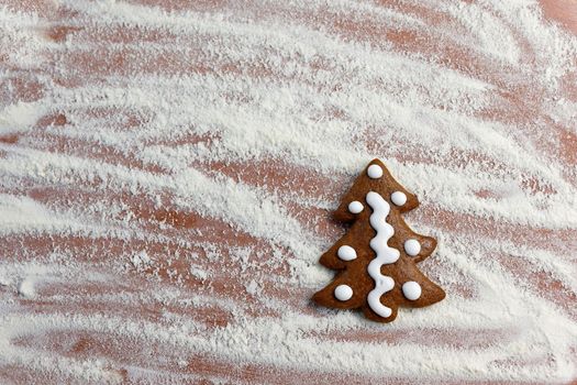 Homemade baking of Christmas cookies in the kitchen.
Gingerbread Christmas tree on table with flour and rolling pin.