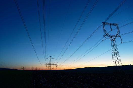 High voltage pylons. Rising energy prices - a concept for industry and energy. Increasing the price of electricity. Concept for industry and energy. The crisis in Europe caused by Russian aggression and the war in Ukraine.