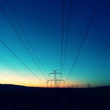 High voltage pylons. Rising energy prices - a concept for industry and energy. Increasing the price of electricity. Concept for industry and energy. The crisis in Europe caused by Russian aggression and the war in Ukraine.