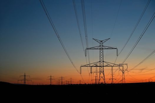 High voltage pylons. Rising energy prices - a concept for industry and energy. Increasing the price of electricity. Concept for industry and energy. The crisis in Europe caused by Russian aggression and the war in Ukraine.