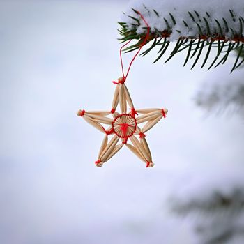 Ornaments and lights on the decorated Christmas tree. 
Christmas decorations on the holiday. Colorful balls garland glowing lamps and red berries on the branches are sprinkled with snow.Festive traditional seamless background for the New Year