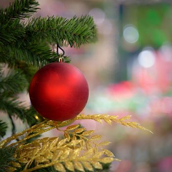 Ornaments and lights on the decorated Christmas tree. 
Christmas decorations on the holiday. Colorful balls garland glowing lamps and red berries on the branches are sprinkled with snow.Festive traditional seamless background for the New Year