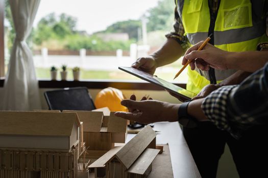 Architect man working with blueprints for architectural plan, engineer sketching a construction project concept.