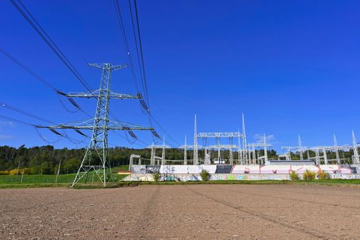 Power plant - electrical energy substation.- High voltage pylons. Concept for technology and industry. Rising energy prices - further rising electricity and energy prices - the energy crisis caused by the war between Russia and Ukraine.