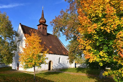 Beautiful autumn landscape with old Chapel of the Mother of God in Veveří. Sunset and beautiful blue sky with clouds. Colorful nature background on autumn season. Brno - Czech Republic.