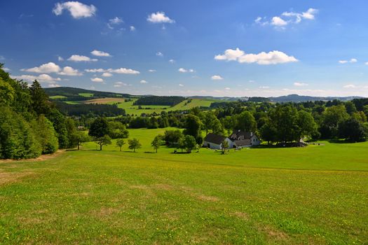 Beautiful summer landscape with nature. Meadow with forest and blue sky on a sunny day. Highlands - Czech Republic.