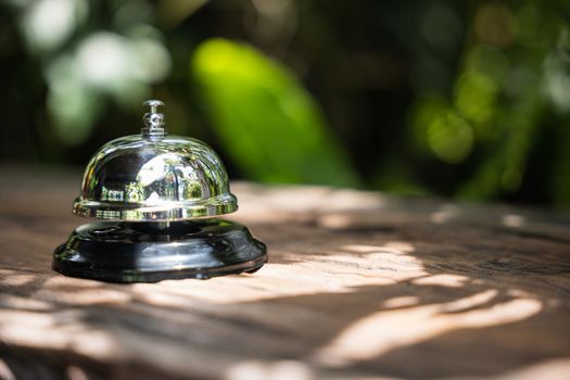 Hospitality hotel. Customer hand ringing service bell at coffee cafe shop for calling the staff to receive the menu, Woman finger touching to ring bell