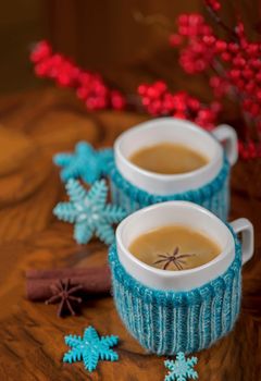 Coffee in cups with cardamom and white sugar on vintage wooden background