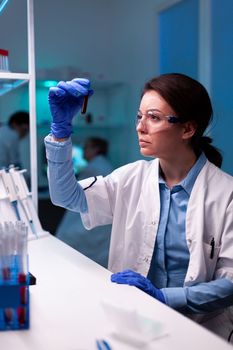 Scientist holding vacutainer blood sample in laboratory healthcare. Researcher in chemical medicine lab working with professional technology equipment for healthcare development.