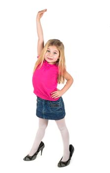 Little girl wearing big high-heeled mother's shoes isolated on white background