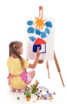 The child is drawing. Children's painting. Little girl draws the sun. The schoolboy does his homework in art. Paint on children's hands. Creative little artist at work. Isolated on a white background