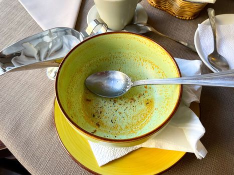 Dirty dishes after soup lunch in a cafe. Selective focus. Delicious food concept.