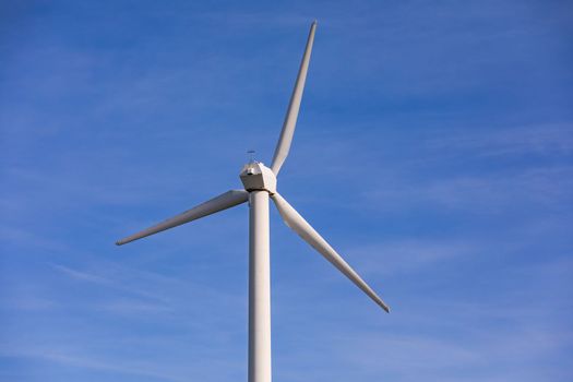 Aerial view of a wind turbine with red and white propellers