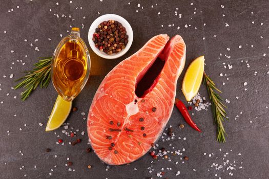 Salmon steak on a black background with spices