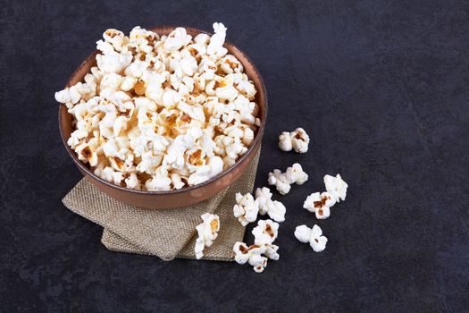 Popcorn in bowl food on black stone background